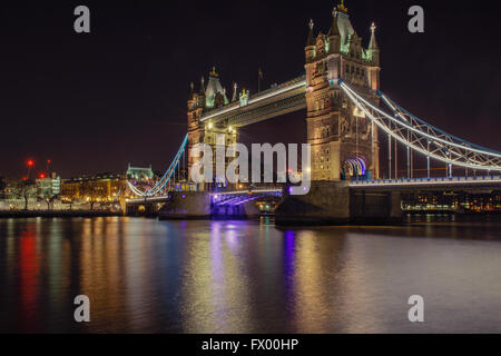 Tower Bridge in London, UK, beleuchtet in der Nacht mit Reflexion von Themse Stockfoto
