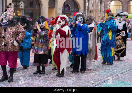 Eine ganze Gruppe von Basel-Karneval-Teilnehmer in ihren bunten Kostümen durch den alten Teil der Stadt marschieren Stockfoto
