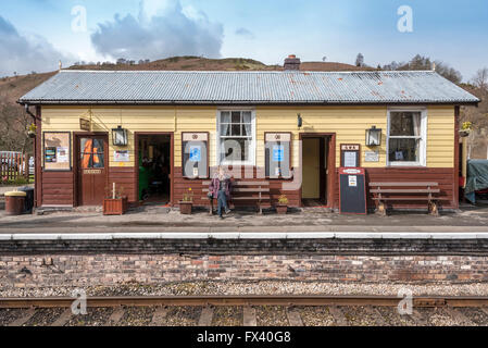 Llangollen Eisenbahn Spring Steam Gala April 2016. Glyndyfrdwy Bahnhof. Ein Passagier wartet auf einen Zug auf einer Bank sitzen. Stockfoto