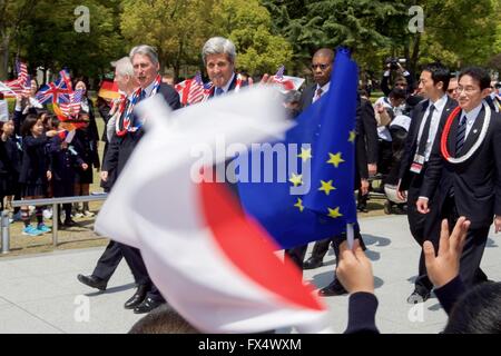 Hiroshima, Japan. 11. April 2016. US Staatssekretär John Kerry geht mit anderen G7-Außenminister und British Foreign Secretary Philip Hammon, links, wie sie bei einem Besuch der Hiroshima Peace Memorial während einer Pause von Sitzungen 11. April 2016 in Hiroshima, Japan von Schulkindern begrüßt werden. Das Denkmal ist die Website die erste Atombombe fiel um den zweiten Weltkrieg Pazifik Kampagne beenden und Kerry wurde der ranghöchste US-Beamter zum Besuch der Website seit dem Krieg. Bildnachweis: Planetpix/Alamy Live-Nachrichten Stockfoto