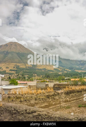 Ländliches Motiv Landschaft Armenhäuser und hohe Berge im Hintergrund von der Autobahn in die Außenseiten von Quito, Ecuador Stockfoto