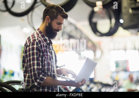 Fahrradmechaniker Überprüfung Laptops Stockfoto