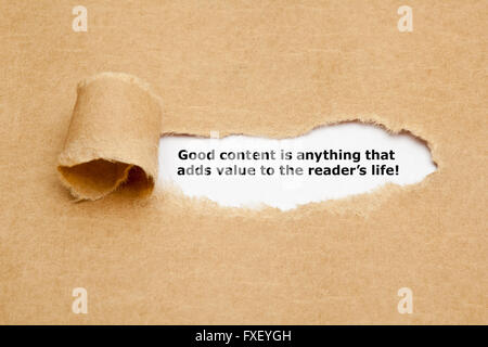 Das Angebot guter Inhalt ist alles, die Mehrwert für den Leser leben, erscheint hinter zerrissenes braunen Papier. Stockfoto