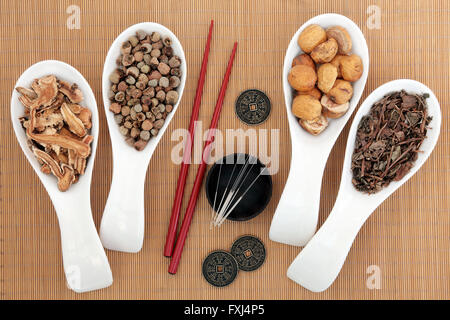 Akupunktur-Nadeln und traditionelle chinesische Medizin-Auswahl mit Stäbchen und I Ching Münzen über Bambus Hintergrund. Stockfoto