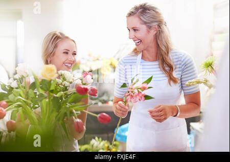 Lachend Floristen arrangieren Bukett im Blumenladen Stockfoto