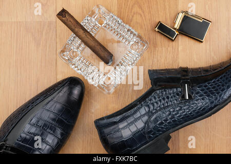 Männliche Stillleben, klassische Herrenschuhe und eine Zigarre in einem Aschenbecher können als Hintergrund verwenden. Stockfoto