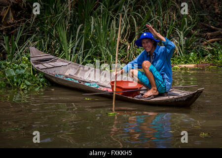 Freundliche Person Winkend aus einem kleinen Boot - vietnamesische Fischer, Chau Doc, Mekong Delta, Vietnam Stockfoto