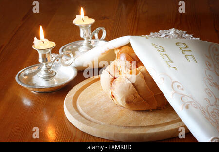 Schabbat Bild. Challah Brot, Schabbat Wein und Candela auf Holztisch Stockfoto