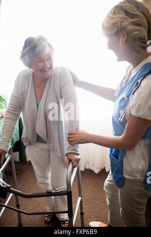 Krankenschwester kümmert sich um eine ältere Frau Stockfoto