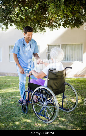 Krankenschwester hilft senior Frau aufzustehen Stockfoto