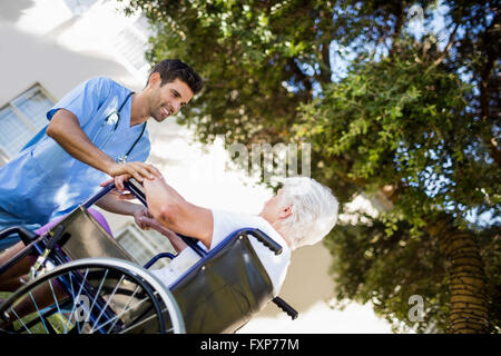 Krankenschwester hilft senior Frau aufzustehen Stockfoto