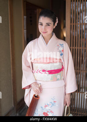 Japanische Frau tragen Kimono Schritte aus einem traditionellen Haus in Kyoto, Japan Stockfoto