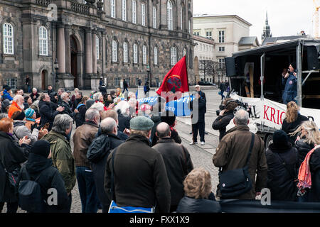 Kopenhagen, Dänemark, 19. April 2016. Demonstranten auf dem Bundesplatz demonstrieren gegen einen Gesetzentwurf im Parlament, Christiansborg (Hintergrund), die die dänische militärische Engagement im Kampf gegen islamische Staat in Syrien zu erhöhen, wird gleichzeitig verhandelt wird. Das Gesetz wurde verabschiedet, und bedeutet, dass f-16 Luft Kämpfern, Hercules-Transportflugzeug und Special Forces bald im Krieg eingesetzt werden. Bildnachweis: OJPHOTOS/Alamy Live-Nachrichten Stockfoto