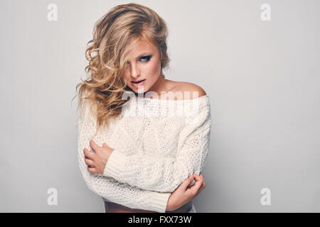 Porträt der schöne blonde Frau in weiß in weißer Pullover Stockfoto