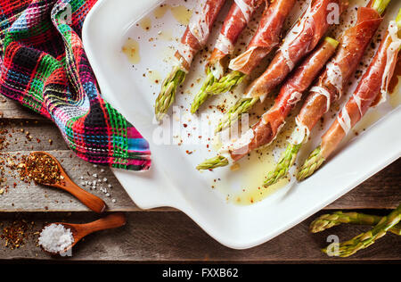 Frischer grüner Spargel in Parmaschinken in Pfanne, Draufsicht gewickelt Stockfoto