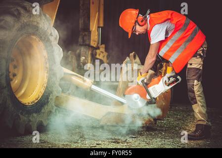 Bauarbeiter in Aktion. Arbeiter Schneiden Beton mithilfe der Heavy-Duty Electric Cutter. Baustelle. Stockfoto