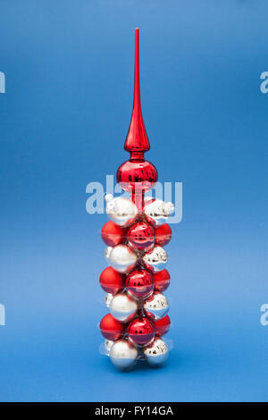 Tree Topper auf rote und silberne Weihnachtsschmuck vor blauem Hintergrund Stockfoto