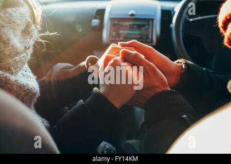 Bild von paar Hand in Hand im Auto beschnitten Stockfoto