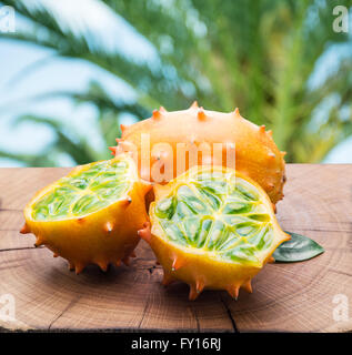 Kiwano Früchte auf dem Holztisch mit der grünen Natur im Hintergrund. Stockfoto