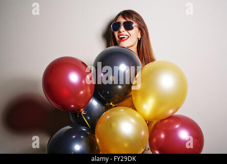 Weibchen mit Luftballons Stockfoto