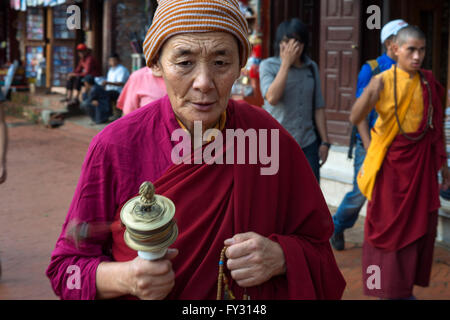 Mann mit einem Mani-Mühle in Boudhanath Stupa, Kathmandu, Nepal. Mani-Mühle, Bodhnath Stupa, Kathmandu, Nepal, Asien Stockfoto