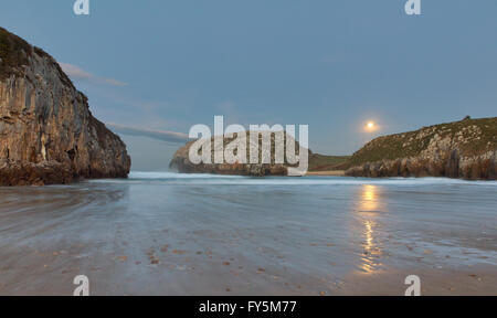 Moon Rising am Strand bei Ebbe in Asturien (Spanien). Playa de Las Cuevas del Mar. Stockfoto