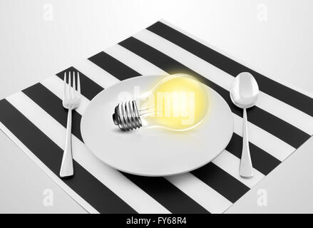 Lampe im Teller und Gabel und Löffel, dient eine Idee-Konzept Stockfoto