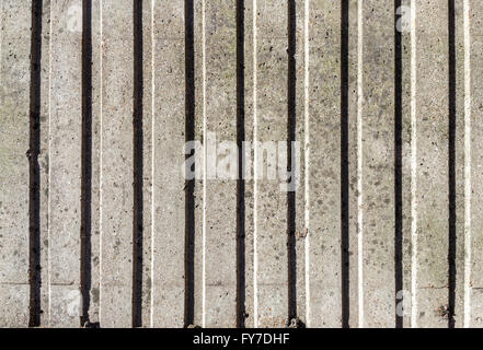 Verwittert und gefärbten graue Betonwand mit vertikalen Muster für den Hintergrund Stockfoto