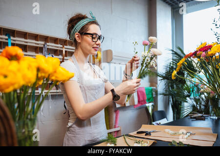 Glücklich charmante junge Frau Floristen halten schöne Blumen und Strauß im shop Stockfoto