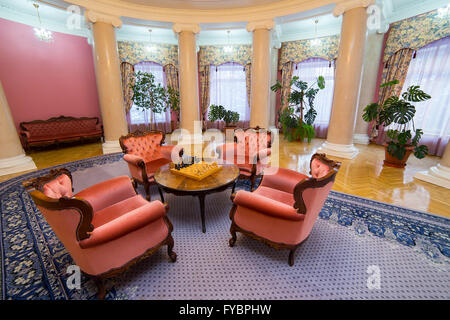 Klassische Luxus Runde Halle mit Säulen, Schach Schreibtisch und klassischen hölzernen Sofa und Sessel Stockfoto