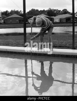 Reifer Mann tun Poolpflege zu seinem Florida Pool Zuhause, 25. April 2016 Stockfoto