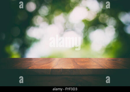 Leere Top Holztisch und floralen unscharfen Hintergrund Stockfoto