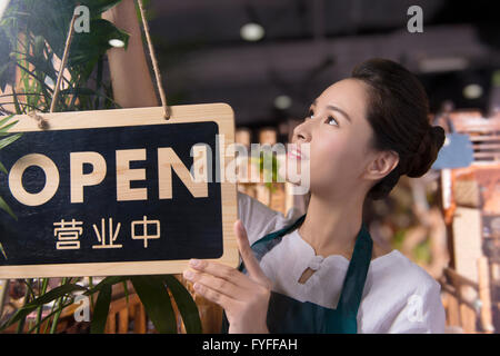 Tee-Hauseigentümer aufstellen Schild "geöffnet" Stockfoto