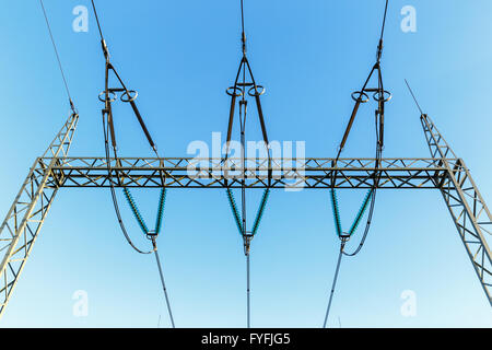 Hochspannungs-Strommasten gegen blauen Himmel Stockfoto