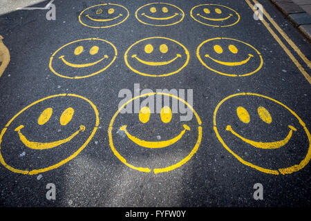 Smiley-Gesichter auf der Straße in Brighton gemalt. Stockfoto