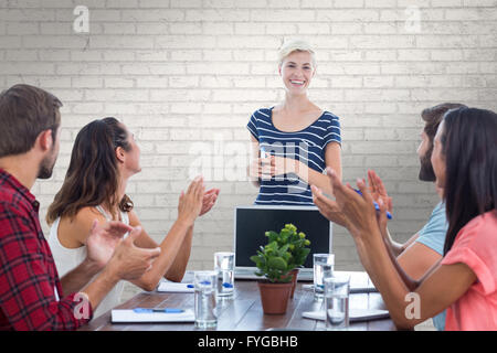 Zusammengesetztes Bild Kollegen Händeklatschen in einer Besprechung Stockfoto