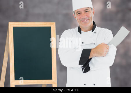 Zusammengesetztes Bild des Mannes in Chef einheitliche Fleischerbeil holding Stockfoto