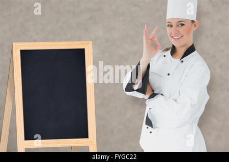 Zusammengesetztes Bild der glückliche Köchin Stockfoto