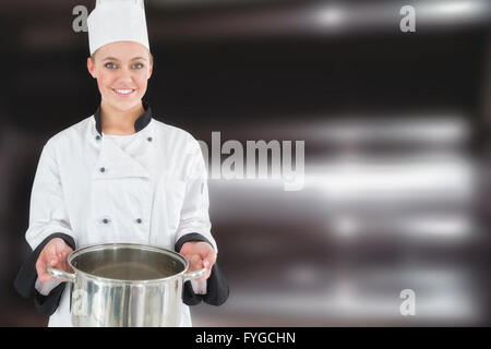 Zusammengesetztes Bild der glückliche Köchin halten Küchenutensil Stockfoto