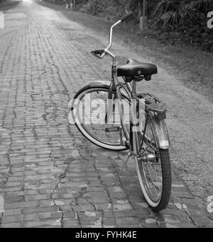 klassische amerikanische Kreuzer gestylt Fahrrad auf einer alten Backstein-Landstraße. April 2016 Stockfoto