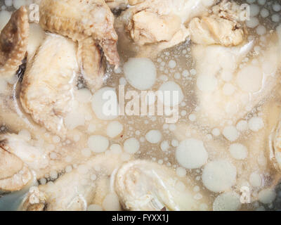 kalte gekochte Hähnchenflügel in gefrorenen fettig Hühnerbouillon Stockfoto