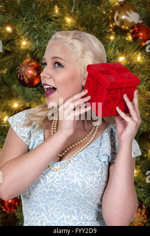 Schöne Frau schütteln Geschenk Stockfoto