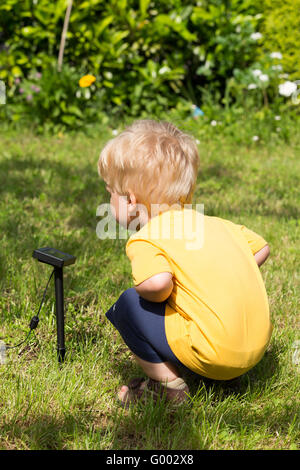 Kind durch Solarbatterie interessiert Stockfoto