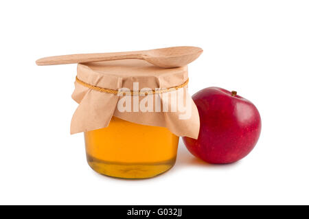 Honig im Glas Holzlöffel roten Apfel isoliert. Stockfoto