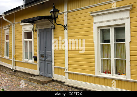 Ocker-gelbe Fassade von einem finnischen Blockhaus Stockfoto