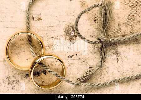 Zwei goldene Hochzeit Ringe mit Schnur gebunden Stockfoto