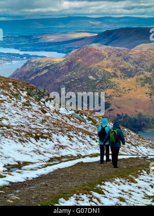 Winterwanderer zu Fuß vom Gipfel des Lakelandpoeten in Richtung Ullswater im Lake District National Park Cumbria England UK Stockfoto