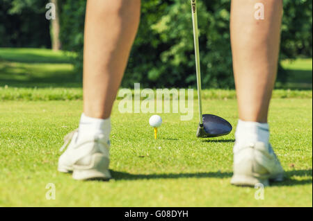 Beine eines Golfers mit Golfball und Golfschläger Stockfoto