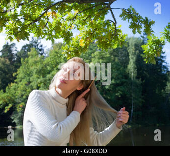 schöne Frau Kämme langes Haar in den Sommertag Stockfoto