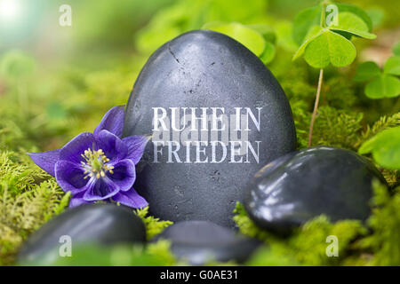 Schwarzer Stein mit den Worten "Ruhe in Frieden" Stockfoto